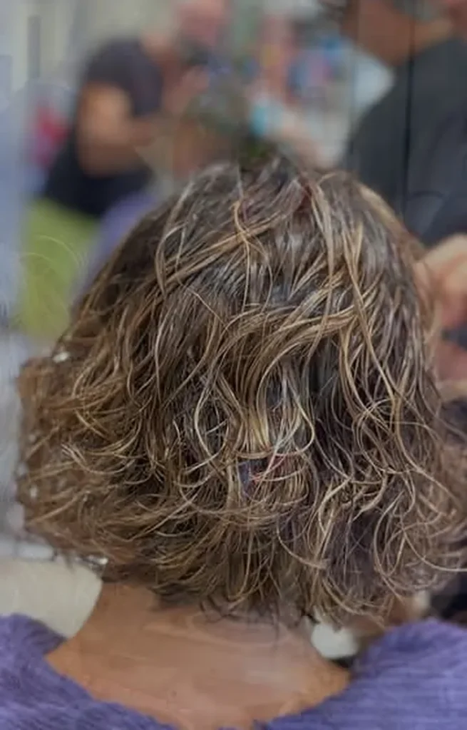 Caschetto riccio con balayage dai riflessi caldi